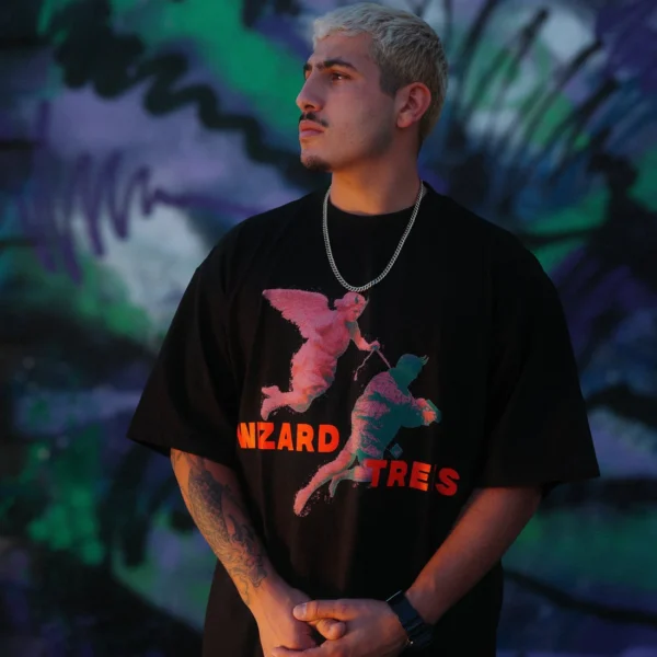 Model wearing the Angel Tee in front of a mural