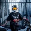 Model wearing the Dove Tee while sitting on a dirt bike at a gate