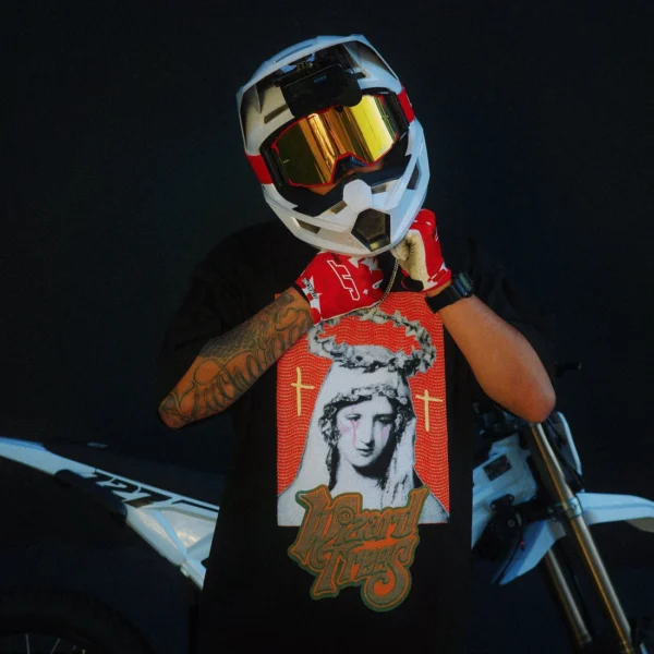 Model wearing the Mary Tee at night next to a dirt bike